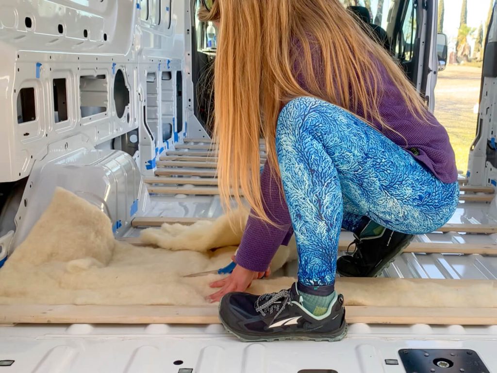 After peeling the Havelock Wool batt insulation in half, we placed it in between the furring strips and cut it to size.