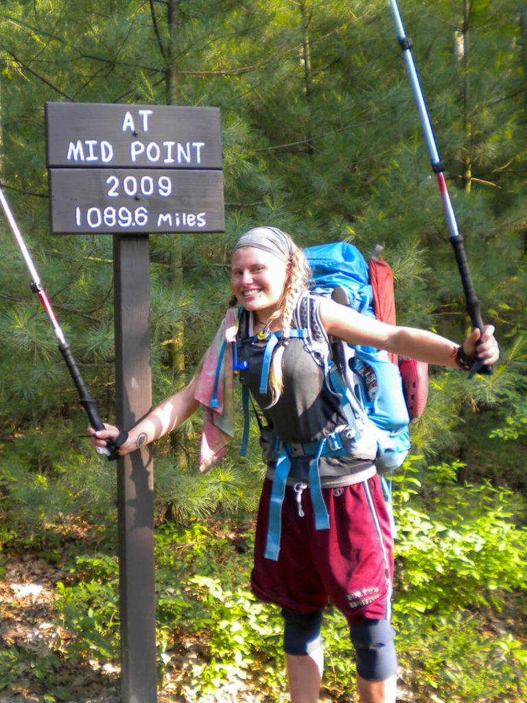 Woman thru-hiker on the Appalachian Trail wearing the Osprey Ariel backpack.