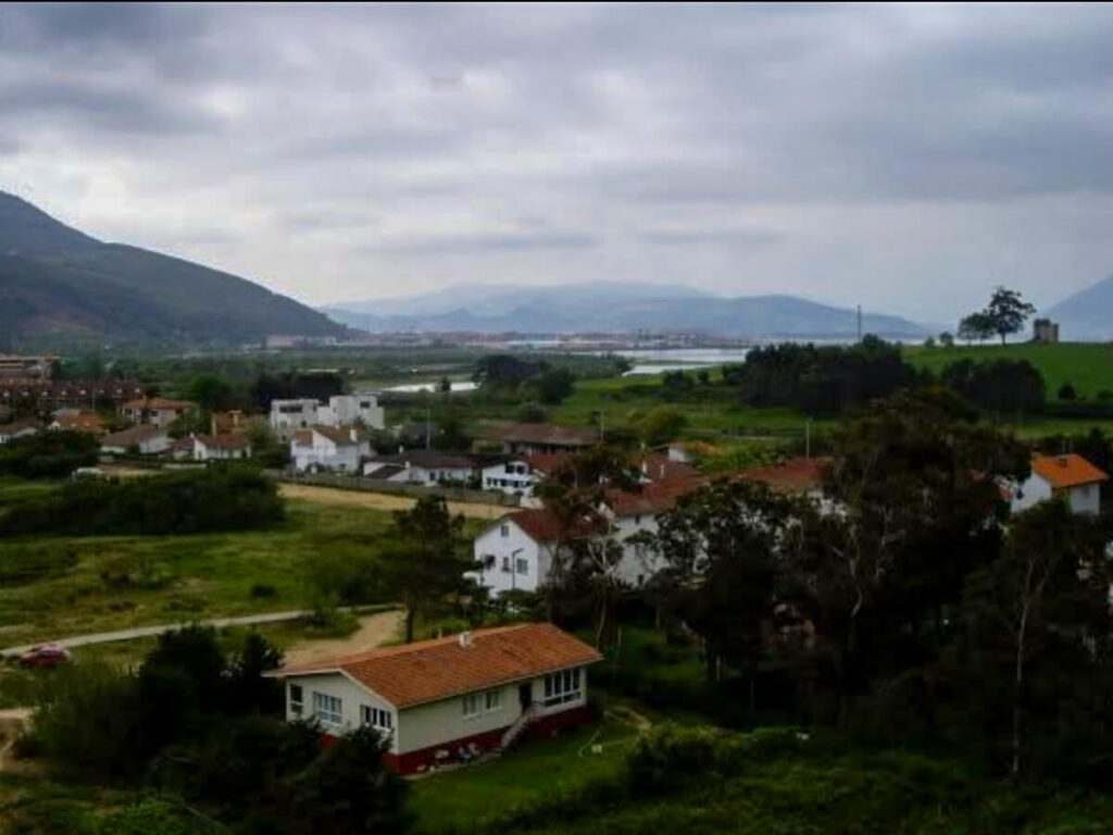 A view into a town on the coast of Spain with overcast weather.