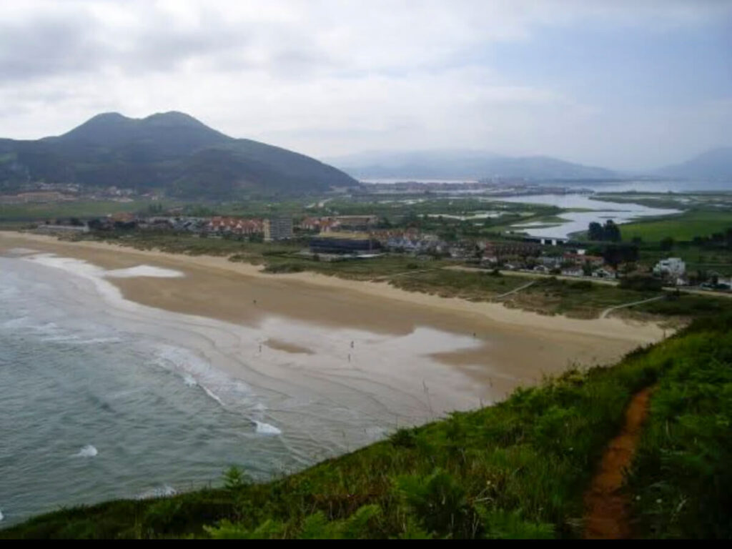 A view of the beach from the bluffs to a town on the Camino del Norte.